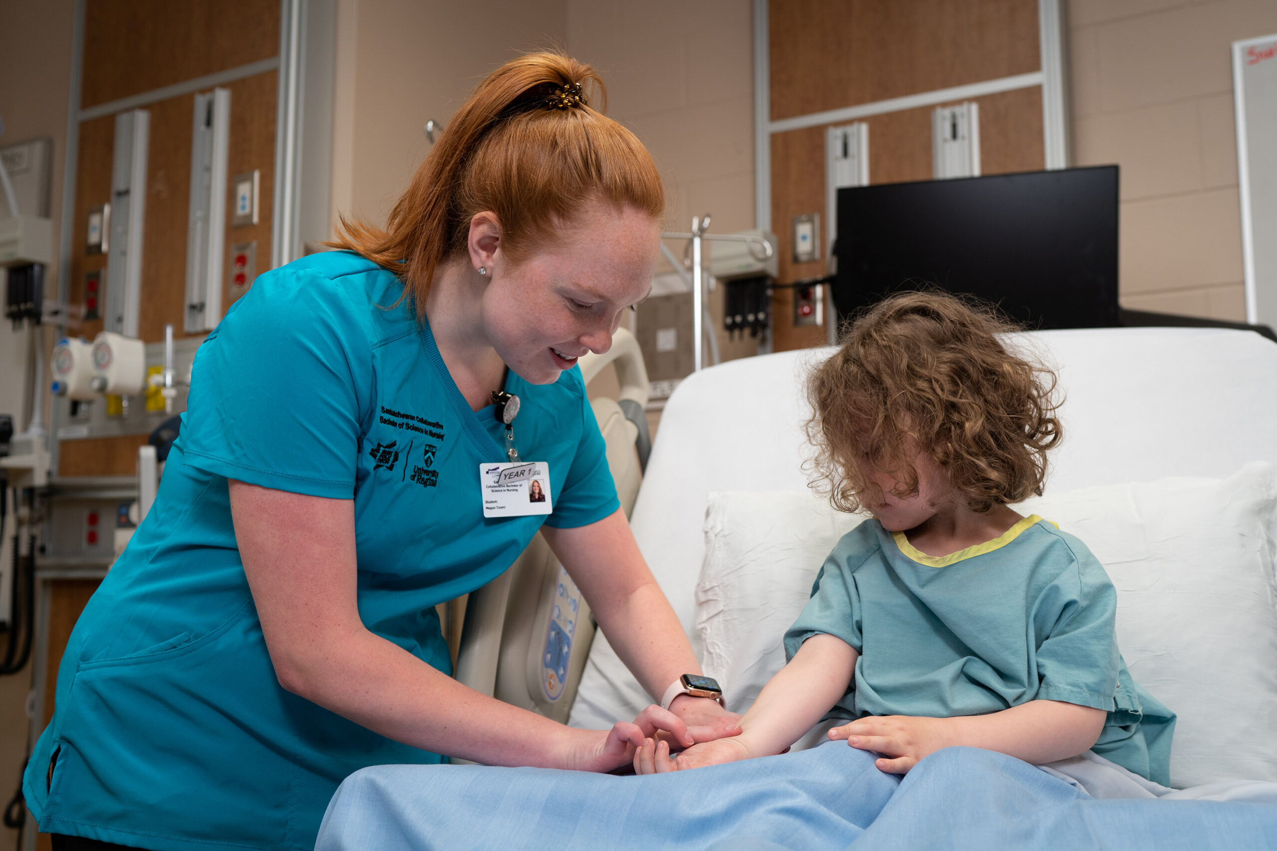 nursing student taking pulse of young girl